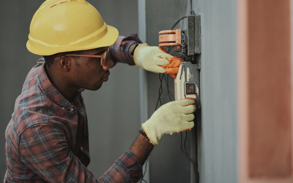 Licensed electrician installing a wall outlet